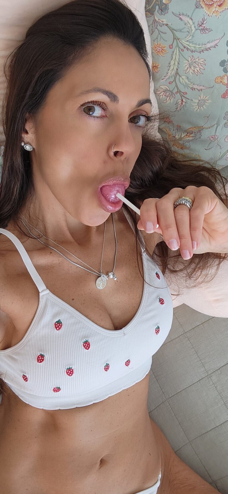 Angelina is sucking a lollipop