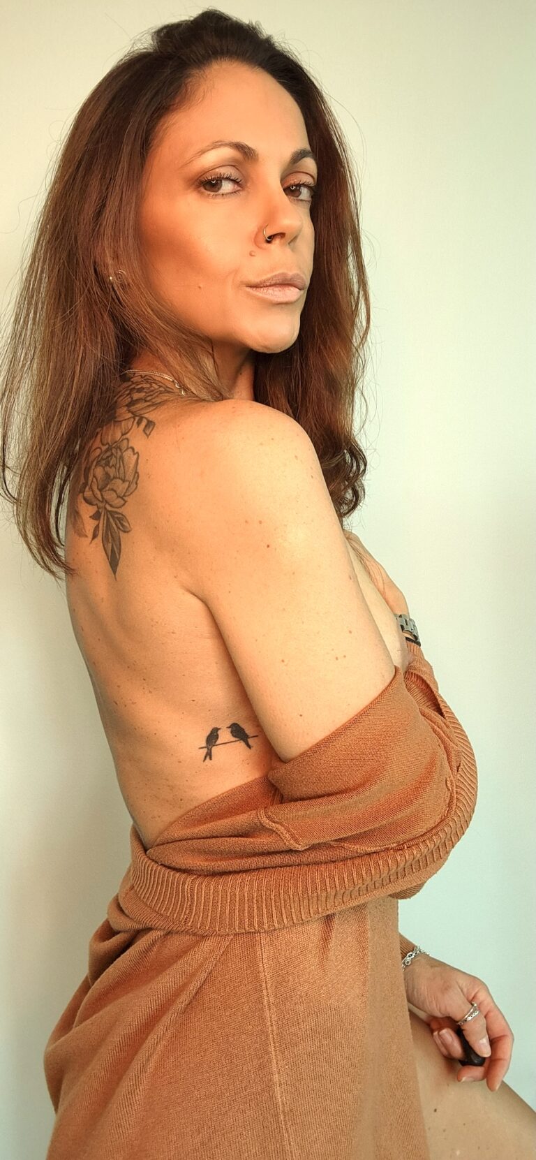Autumn Temptation Angelina shows her tatoo of two birds